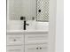 Close-up of a modern white bathroom vanity with black faucet at 2327 Mason Dr # D23, Atlanta, GA 30316