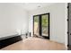 Bedroom with bench seating and black double doors leading to deck at 2327 Mason Dr # D23, Atlanta, GA 30316