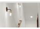 Modern hallway with sconce lighting and natural wood railing at 2327 Mason Dr # D23, Atlanta, GA 30316