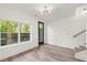 Living area with wood-look floors, contemporary lighting, and view to the fenced backyard at 2327 Mason Dr # D23, Atlanta, GA 30316