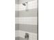 Close up of shower with grey and white horizontal striped tile at 2327 Mason Dr # D23, Atlanta, GA 30316