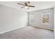 Bedroom featuring neutral carpet, ceiling fan, and natural light at 404 Ridgefield Dr, Peachtree City, GA 30269