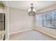 Dining room showcasing chandelier lighting and natural light through large windows at 404 Ridgefield Dr, Peachtree City, GA 30269