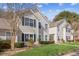 Inviting two-story townhome featuring a lush green lawn and manicured shrubs at 404 Ridgefield Dr, Peachtree City, GA 30269