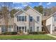 Charming two-story townhome with classic siding, black shutters, and a well-manicured lawn at 404 Ridgefield Dr, Peachtree City, GA 30269