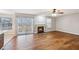 Bright and airy living room with hardwood flooring, fireplace, and sliding glass doors at 404 Ridgefield Dr, Peachtree City, GA 30269