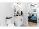 Stylish bathroom with a modern vanity, arched mirror, and doorway view to a bedroom at 4834 Neal Rdg, Atlanta, GA 30349