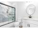 Bright bathroom featuring a glass shower with a black frame, a toilet, and a vanity at 4834 Neal Rdg, Atlanta, GA 30349