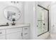 Bathroom featuring a glass shower, toilet, vanity and a round mirror at 4834 Neal Rdg, Atlanta, GA 30349