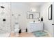 Elegant bathroom with a marble-tiled shower and a sleek white vanity with modern fixtures at 4834 Neal Rdg, Atlanta, GA 30349