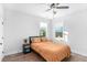 Bright bedroom with wood floors, two windows, a ceiling fan and a comfortable bed at 4834 Neal Rdg, Atlanta, GA 30349