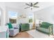 Cozy Bedroom featuring a green crib, dresser, soft chair, hardwood floors and two windows for natural light at 4834 Neal Rdg, Atlanta, GA 30349