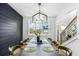 Formal dining room with a large table, modern chandelier, and an accent wall at 4834 Neal Rdg, Atlanta, GA 30349