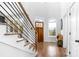 Bright entry way featuring hardwood floors, a staircase with modern railing and bench seating at 4834 Neal Rdg, Atlanta, GA 30349