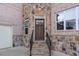 Inviting front entrance with a wood door, stone accents, and steps leading to the entrance at 4834 Neal Rdg, Atlanta, GA 30349