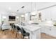 Modern kitchen boasts a white marble countertop island with seating and stylish pendant lights at 4834 Neal Rdg, Atlanta, GA 30349