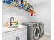 Well-equipped laundry room with modern washer/dryer and ample countertop space at 4834 Neal Rdg, Atlanta, GA 30349