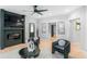 Cozy living room with fireplace, ceiling fan, modern artwork, and sleek furniture at 4834 Neal Rdg, Atlanta, GA 30349