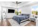 A bright main bedroom features a tray ceiling, tv and scenic windows at 4834 Neal Rdg, Atlanta, GA 30349