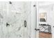 Luxurious marble tiled shower with glass door adjacent to a bedroom entrance at 4834 Neal Rdg, Atlanta, GA 30349