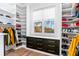 Spacious walk-in closet featuring custom shelving, drawers, and a window offering natural light at 4834 Neal Rdg, Atlanta, GA 30349