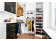 Organized walk-in closet with black and white shelving, drawers, and hanging rods for efficient storage at 4834 Neal Rdg, Atlanta, GA 30349