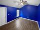 This bedroom boasts striking blue walls and wood-look flooring at 5735 Hedge Brook Dr, Cumming, GA 30028