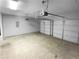 Spacious garage with a three-panel white garage door and an automatic opener at 5735 Hedge Brook Dr, Cumming, GA 30028