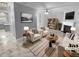 Bright living room with modern furnishings, a fireplace, and sleek marble floors at 5735 Hedge Brook Dr, Cumming, GA 30028