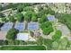 An aerial view of the community tennis courts and pool surrounded by lush trees at 7015 Polo Dr, Cumming, GA 30040