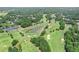 An aerial view of the golf course showing the many sand traps and lush green landscape at 7015 Polo Dr, Cumming, GA 30040