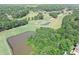 Aerial view showcasing the golf course pond and surrounding neighborhood landscape at 7015 Polo Dr, Cumming, GA 30040