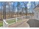 Charming back deck offers ample space for outdoor seating and enjoying the serene, wooded backyard view at 7015 Polo Dr, Cumming, GA 30040