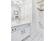 Bathroom with vanity and shower-tub combo with patterned shower curtain at 7015 Polo Dr, Cumming, GA 30040