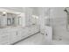 Luxurious bathroom with a glass-enclosed shower, double vanity, and marble floors at 7015 Polo Dr, Cumming, GA 30040