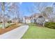 Lovely two-story house featuring mature trees, a sprawling lawn, and a curved driveway at 7015 Polo Dr, Cumming, GA 30040