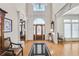 Elegant foyer with hardwood flooring, a decorative rug, and a stunning arched doorway at 7015 Polo Dr, Cumming, GA 30040