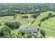 Aerial view of golf course, clubhouse, and surrounding trees with residential homes in the background at 7015 Polo Dr, Cumming, GA 30040