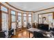 Dedicated home office with custom wood trim, shuttered windows, and a workspace bathed in natural light at 7015 Polo Dr, Cumming, GA 30040