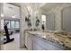 Bathroom with granite countertop, decorative fixtures, and access to the bedroom with ceiling fan and treadmill at 870 Waddington Ct, Atlanta, GA 30350