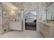 Primary bath featuring dual vanities, tile flooring, decorative wallpaper, and a glimpse into the primary bedroom at 870 Waddington Ct, Atlanta, GA 30350