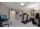 Well lit secondary bedroom featuring home gym equipment including a treadmill, a computer desk, and a weight bench at 870 Waddington Ct, Atlanta, GA 30350