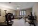 Bedroom featuring a ceiling fan, a treadmill, a bed with striped linens, and a desk at 870 Waddington Ct, Atlanta, GA 30350