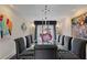 Dining room with a glass table, contemporary art, and modern lighting at 870 Waddington Ct, Atlanta, GA 30350