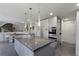 Open concept kitchen with a large island, gray countertops, tile floors, and pendant lighting at 870 Waddington Ct, Atlanta, GA 30350