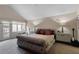 Main bedroom featuring a high ceiling, a plush upholstered bed, and two side tables with lamps at 870 Waddington Ct, Atlanta, GA 30350