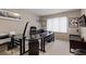 Well-lit home office with glass desk, large window, comfortable seating, and tasteful wall art at 870 Waddington Ct, Atlanta, GA 30350