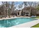 Large in-ground swimming pool surrounded by a spacious deck and lounge chairs at 870 Waddington Ct, Atlanta, GA 30350