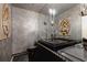 Unique powder room with an intricate sink and faucet, modern lighting, and textured walls at 870 Waddington Ct, Atlanta, GA 30350