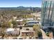 Aerial view of a condo building showing neighborhood, trees, and downtown in the distance at 91 Rumson Ne Rd # C34, Atlanta, GA 30305